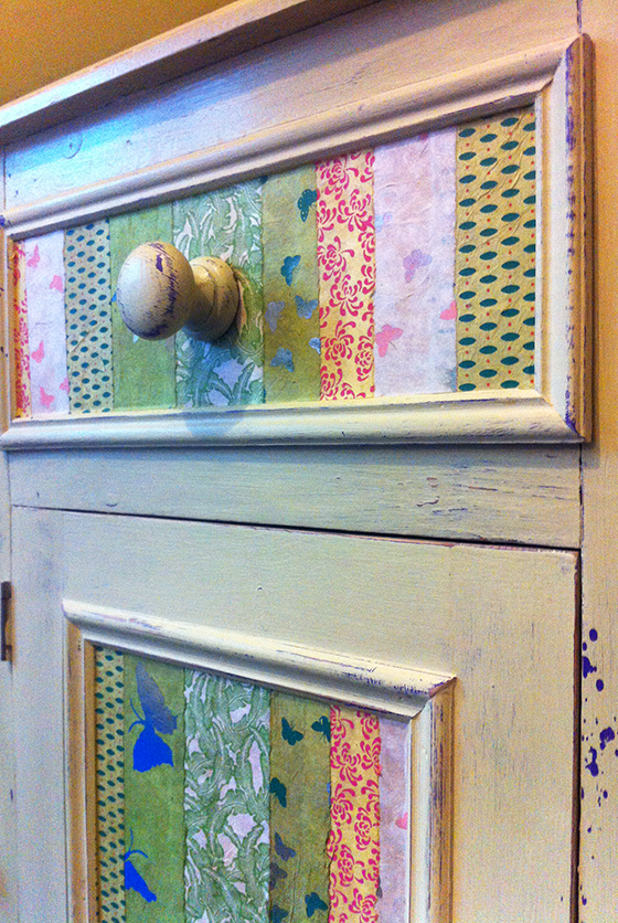 Dresser distressed with decoupaged inlays